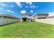 This spacious backyard features a well-manicured lawn, a screened-in lanai, and a sturdy white fence for ultimate privacy at 5735 Bungalow Grove Ct, Palmetto, FL 34221