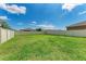 Expansive backyard featuring lush green grass, enclosed by a white vinyl fence, perfect for outdoor activities and privacy at 5735 Bungalow Grove Ct, Palmetto, FL 34221