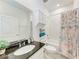 Bright bathroom with modern fixtures and a vanity with granite countertop and a shower with tub combination at 5735 Bungalow Grove Ct, Palmetto, FL 34221