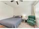 Bedroom with a ceiling fan, carpet flooring, a comfortable bed, and an armchair at 5735 Bungalow Grove Ct, Palmetto, FL 34221