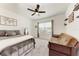 Well-lit bedroom with a ceiling fan, comfortable bed, and futon sofa at 5735 Bungalow Grove Ct, Palmetto, FL 34221