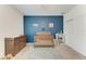 Charming bedroom with blue accent wall and wooden crib at 5735 Bungalow Grove Ct, Palmetto, FL 34221