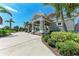 Community pavilion with stone pillars and pergolas, surrounded by lush landscaping and mature palm trees at 5735 Bungalow Grove Ct, Palmetto, FL 34221