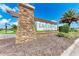 The Eave's Bend at Artisan Lakes community sign, built with stone and wood, adds charm to the neighborhood at 5735 Bungalow Grove Ct, Palmetto, FL 34221