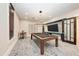 This game room features a modern pool table, a contemporary light fixture, and stylish decor at 5735 Bungalow Grove Ct, Palmetto, FL 34221