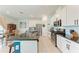 Bright kitchen with white cabinets, stainless steel appliances, and dark countertops at 5735 Bungalow Grove Ct, Palmetto, FL 34221