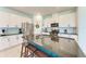 Modern kitchen featuring granite countertops, stainless steel appliances, and a breakfast bar with seating at 5735 Bungalow Grove Ct, Palmetto, FL 34221