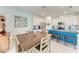 Bright eat-in kitchen with white cabinets, stainless steel appliances, and a center island with bar seating at 5735 Bungalow Grove Ct, Palmetto, FL 34221