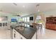 Open-concept kitchen and living area with access to the backyard at 5735 Bungalow Grove Ct, Palmetto, FL 34221