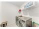Laundry room with tile flooring, shelving, and a modern washer and dryer at 5735 Bungalow Grove Ct, Palmetto, FL 34221