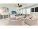 Bright living room with comfortable seating, a ceiling fan, and plenty of natural light from large windows at 5735 Bungalow Grove Ct, Palmetto, FL 34221