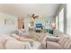 Comfortable living area with modern decor, a stylish ceiling fan, and abundant natural light at 5735 Bungalow Grove Ct, Palmetto, FL 34221