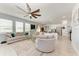 Open-concept living area with modern furnishings, a ceiling fan, and seamless flow to the kitchen at 5735 Bungalow Grove Ct, Palmetto, FL 34221