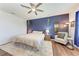 Spacious primary bedroom with a ceiling fan, wood floors, and a blue accent wall at 5735 Bungalow Grove Ct, Palmetto, FL 34221