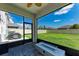 Screened in patio with a view of the backyard and an outdoor fireplace at 5735 Bungalow Grove Ct, Palmetto, FL 34221