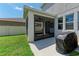 Backyard screened in patio with a grill and view of the fenced in lawn at 5735 Bungalow Grove Ct, Palmetto, FL 34221