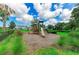This park features a charming playground with a natural setting, blending recreation with nature at 5735 Bungalow Grove Ct, Palmetto, FL 34221