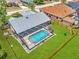 An aerial view of the home featuring a screened-in pool, lush lawn, and privacy fence at 5742 39Th Street E Cir, Bradenton, FL 34203