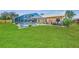 Large backyard featuring a screened-in pool, well-kept lawn and a privacy fence, ideal for outdoor relaxation at 5742 39Th Street E Cir, Bradenton, FL 34203