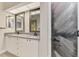 Bathroom featuring a double vanity with modern fixtures and decorative mirrors at 5742 39Th Street E Cir, Bradenton, FL 34203