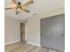 Bedroom with light wood floors, a ceiling fan and closet at 5742 39Th Street E Cir, Bradenton, FL 34203