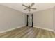 Empty bedroom with light wood floors, a ceiling fan and neutral paint color at 5742 39Th Street E Cir, Bradenton, FL 34203