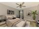 Cozy bedroom with a decorative ceiling fan, neutral tones, and ample natural light at 5742 39Th Street E Cir, Bradenton, FL 34203