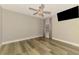 Empty bedroom with light wood floors, a ceiling fan and neutral paint color at 5742 39Th Street E Cir, Bradenton, FL 34203