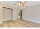 Bedroom with light wood floors and a view into the hallway through decorative doors at 5742 39Th Street E Cir, Bradenton, FL 34203