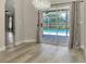 Bright dining area with view of pool through sliding glass doors and illuminated by elegant chandelier at 5742 39Th Street E Cir, Bradenton, FL 34203