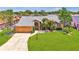 Aerial view showcasing a beautiful single-story home with a spacious yard and a well-manicured lawn at 5742 39Th Street E Cir, Bradenton, FL 34203