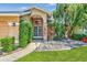 Inviting front entrance with decorative door, enhanced by manicured hedges and stone accents at 5742 39Th Street E Cir, Bradenton, FL 34203