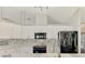 Modern kitchen with stainless steel appliances, updated cabinets, and stylish backsplash at 5742 39Th Street E Cir, Bradenton, FL 34203