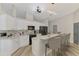 Well-lit kitchen featuring white cabinetry, stainless steel appliances, and counter seating at 5742 39Th Street E Cir, Bradenton, FL 34203