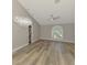 Bright living room with vaulted ceilings, modern lighting, and large window at 5742 39Th Street E Cir, Bradenton, FL 34203