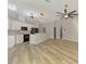 Open floor plan featuring wood floors, a modern kitchen, and bright modern lighting at 5742 39Th Street E Cir, Bradenton, FL 34203