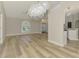 Spacious living room featuring an elegant chandelier, vaulted ceilings, and seamless flow to the kitchen at 5742 39Th Street E Cir, Bradenton, FL 34203