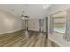 Bright living room featuring wood floors, a modern ceiling fan and natural light at 5742 39Th Street E Cir, Bradenton, FL 34203