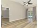 Bright living room with wood floors, a ceiling fan, and sliding glass doors to a pool at 5742 39Th Street E Cir, Bradenton, FL 34203