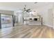 Bright living room featuring an open floor plan, modern kitchen, wood floors and access to a patio at 5742 39Th Street E Cir, Bradenton, FL 34203