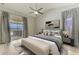 Serene main bedroom featuring a ceiling fan, soft curtains, and sliding doors to the patio at 5742 39Th Street E Cir, Bradenton, FL 34203