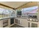 Well-equipped outdoor kitchen with built-in grill, storage, and counter space, designed for culinary enjoyment by the pool at 5742 39Th Street E Cir, Bradenton, FL 34203
