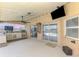 Spacious covered patio with outdoor kitchen, ceiling fan, and access to the pool, offering an ideal spot for outdoor living at 5742 39Th Street E Cir, Bradenton, FL 34203