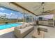 Inviting pool area featuring a screened enclosure, outdoor kitchen, and comfortable seating, perfect for relaxation and entertainment at 5742 39Th Street E Cir, Bradenton, FL 34203