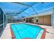 Exterior view of a screened pool area with an outdoor bar and well-kept backyard at 5742 39Th Street E Cir, Bradenton, FL 34203