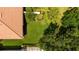 An aerial view of the backyard with lush green grass, mature trees, and landscaping at 5866 Guarino Dr, Sarasota, FL 34238
