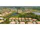 An aerial view of a community with lakes and manicured landscaping at 5866 Guarino Dr, Sarasota, FL 34238