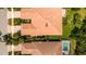 An aerial view of a property featuring a tile roof, lush landscaping, and a refreshing pool at 5866 Guarino Dr, Sarasota, FL 34238