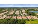 Scenic aerial view of a community surrounded by mature trees at 5866 Guarino Dr, Sarasota, FL 34238