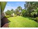 Large, well-maintained backyard featuring lush green grass and landscaping at 5866 Guarino Dr, Sarasota, FL 34238